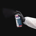 Hand holding a can of SprayMax Structure Paint DTP spray against a black background